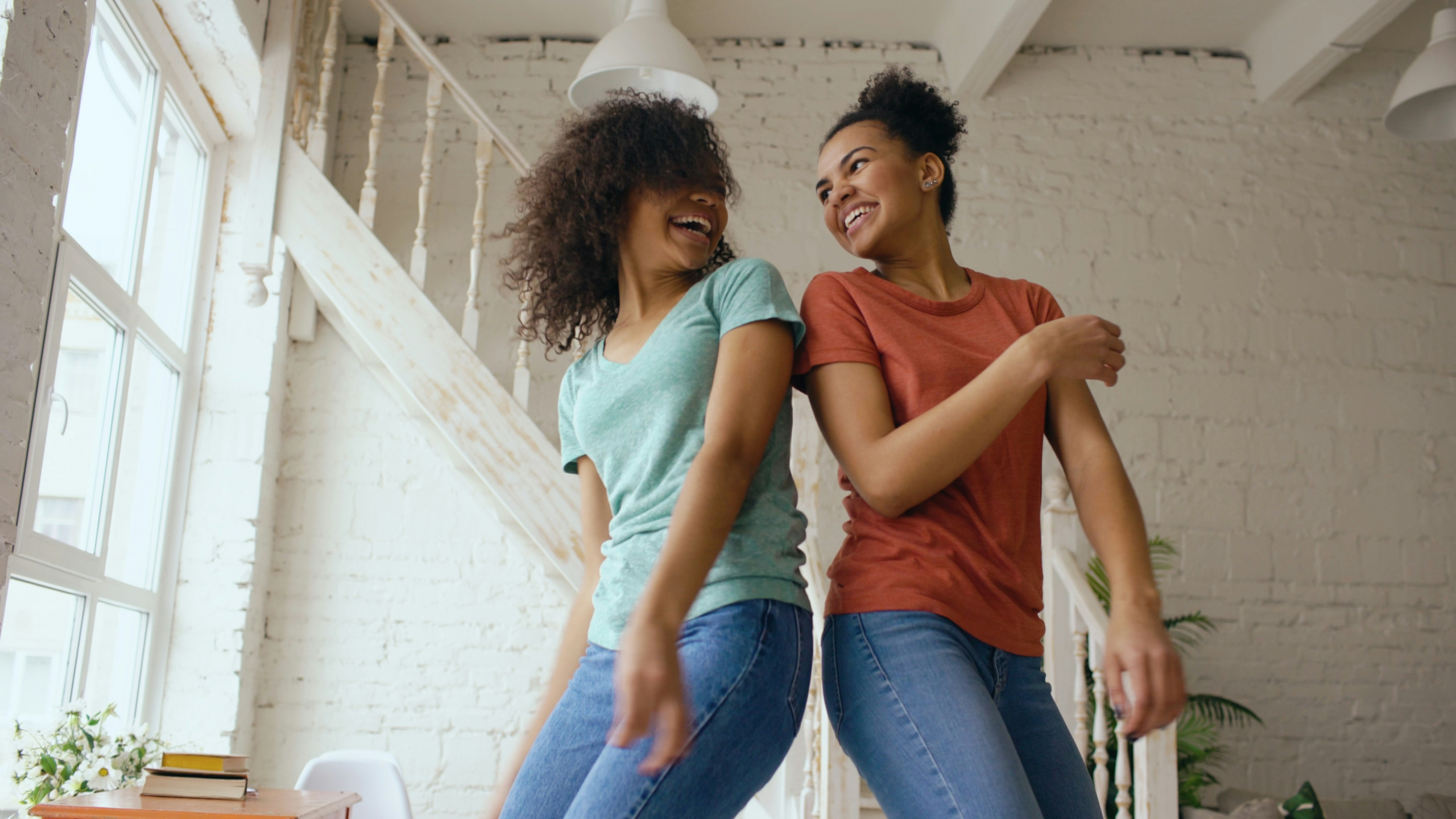 ways to express gratitude without words - Two women dancing together in a living room