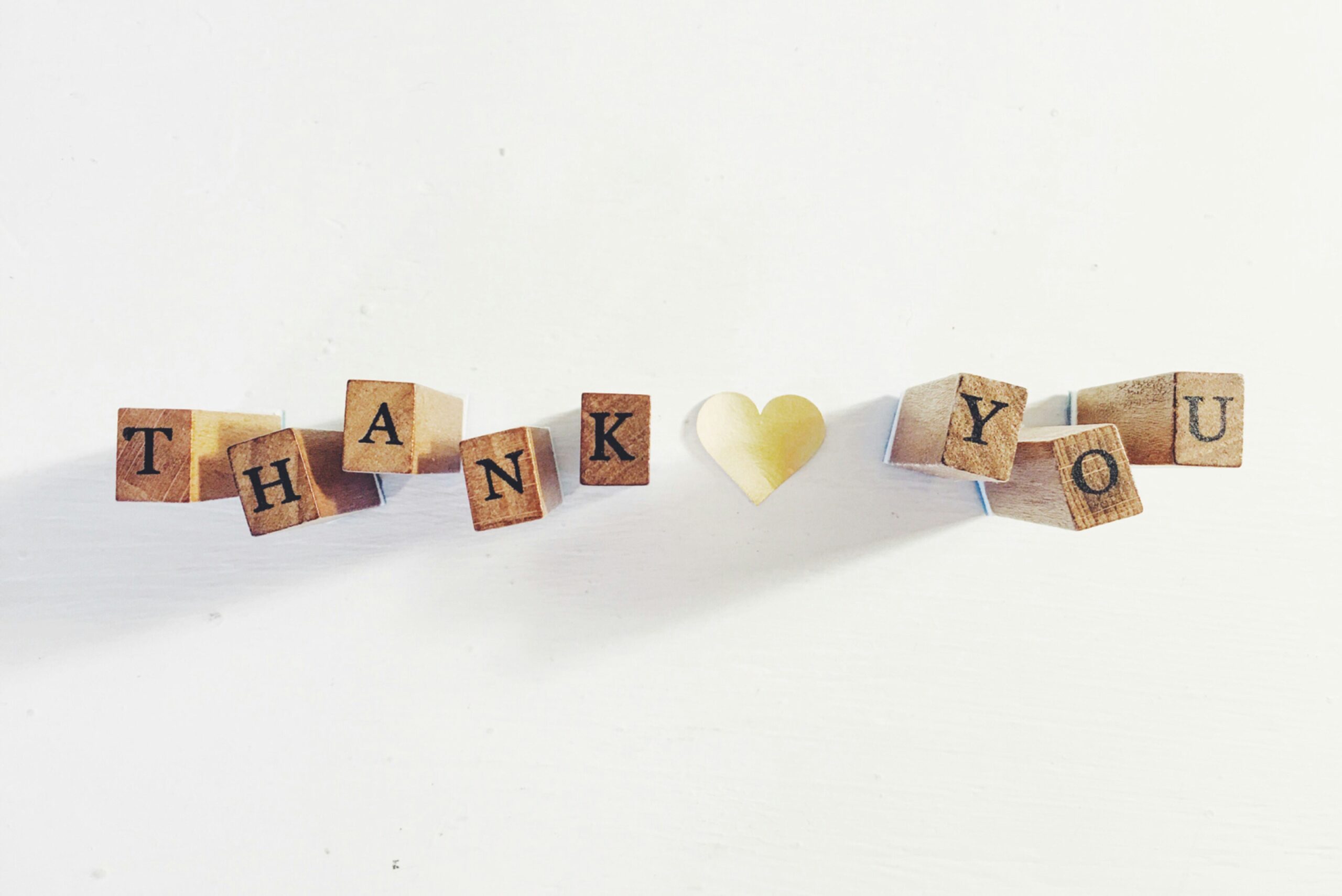 World Gratitude Day messages - Thank you written in blocks with a yellow heart