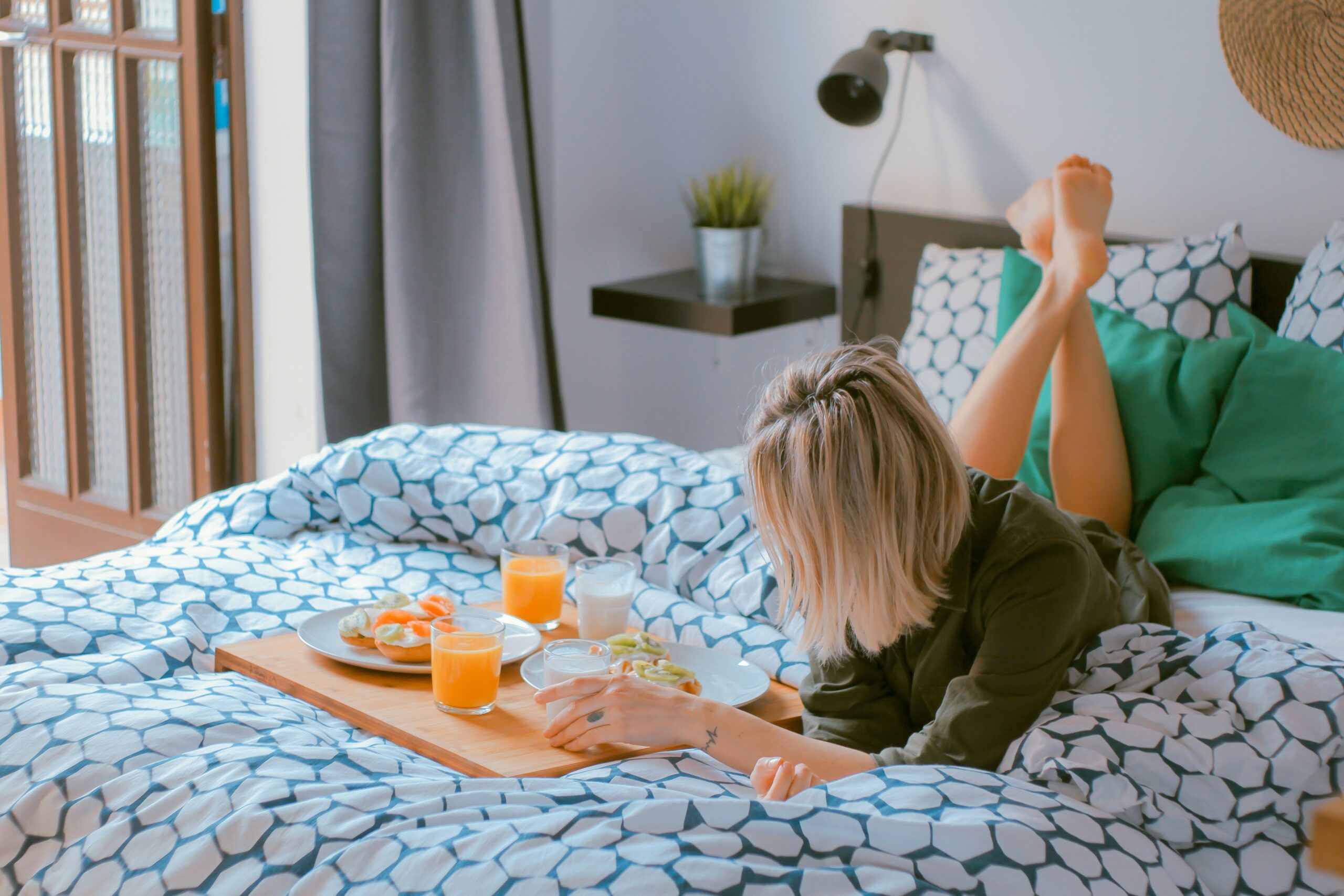 stop comparing your life to others - woman enjoying her bed with a breakfast tray on it