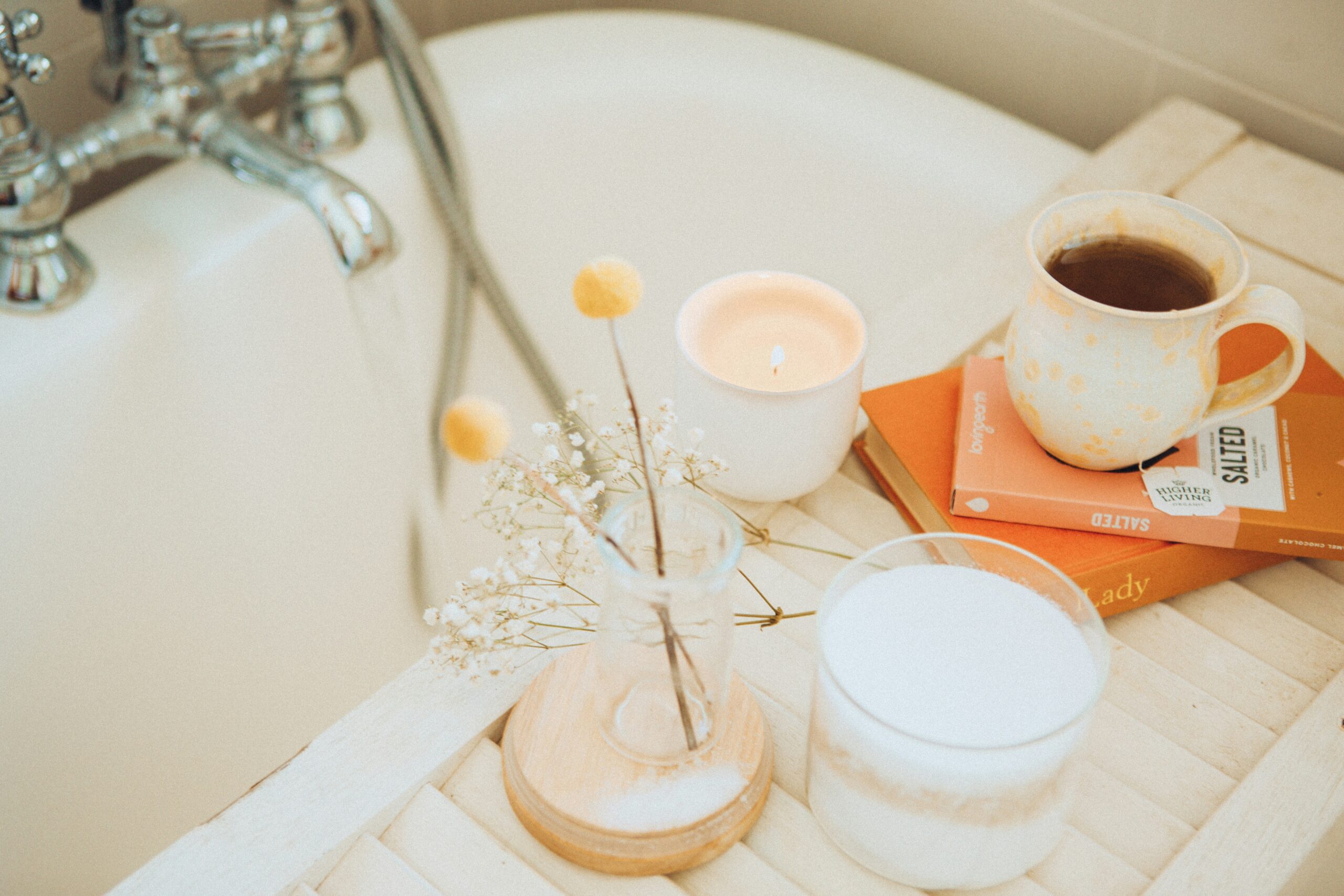 comfort gifts for someone going through a hard time - bath set including candles, books and a warm drink.
